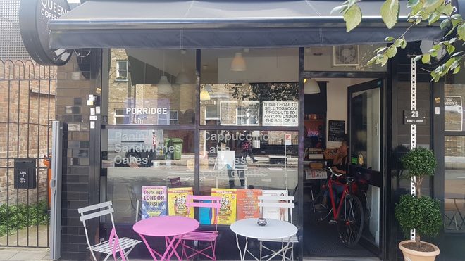 The open shopfront and pavement tables seen from the street