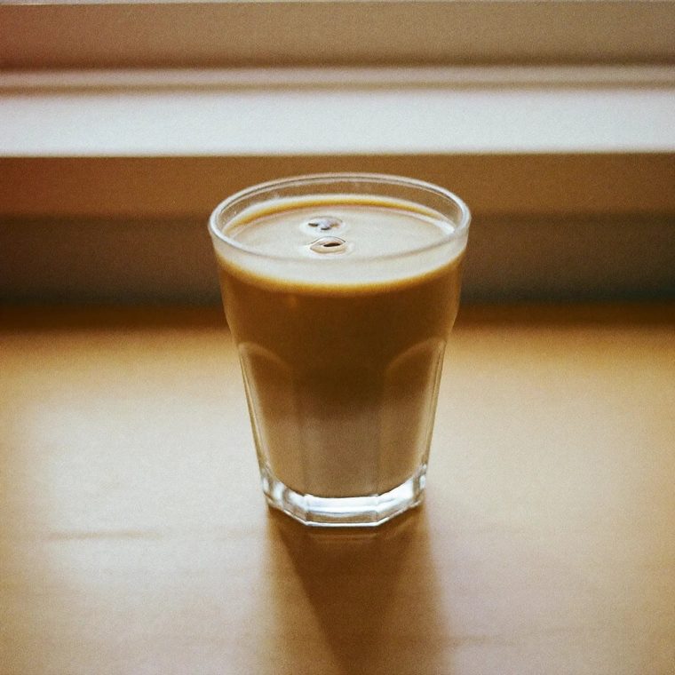 A glass of iced coffee on a wooden table